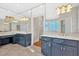 Well-lit bathroom featuring double vanities, and a tiled floor at 239 Trail Nw Rd, Marietta, GA 30064