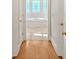 Hallway view into bathroom area featuring a tiled tub and hardwood floors at 239 Trail Nw Rd, Marietta, GA 30064