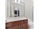 Bathroom with dark wood vanity, a large mirror and a view of the other end of the room at 239 Trail Nw Rd, Marietta, GA 30064