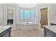 Luxurious bathroom showcasing a soaking tub, stylish vanity, and walk-in shower at 239 Trail Nw Rd, Marietta, GA 30064