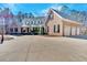 Side view of a brick home featuring a three-car garage and large driveway at 239 Trail Nw Rd, Marietta, GA 30064