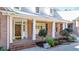 View of the home's front porch with brick detail, white columns, and a black front door at 239 Trail Nw Rd, Marietta, GA 30064