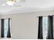 Living room with large windows and black curtains at 239 Trail Nw Rd, Marietta, GA 30064