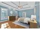 Relaxing main bedroom features tray ceilings, hardwood floors, and a neutral color palette at 239 Trail Nw Rd, Marietta, GA 30064