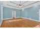 Bright bedroom showcasing hardwood floors, tray ceilings, and spacious layout at 239 Trail Nw Rd, Marietta, GA 30064