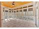 Sun-filled screened porch with tiled floor, offering an ideal space for relaxation with views of the trees at 239 Trail Nw Rd, Marietta, GA 30064