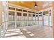 Bright screened-in porch with wooded view, ceiling fan, and tiled flooring for comfortable outdoor living at 239 Trail Nw Rd, Marietta, GA 30064