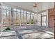The sunroom offers beautiful views of the serene wooded area and a stone floor at 239 Trail Nw Rd, Marietta, GA 30064