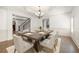 Elegant dining room featuring a modern chandelier, hardwood floors, and ample seating for six at 2480 Flint Creek Dr, Cumming, GA 30041