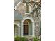 Close-up of the stone facade and arched entryway to the house with a black front door at 2480 Flint Creek Dr, Cumming, GA 30041