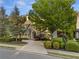 Charming home showcasing stone accents, an arched porch, and mature trees at 2480 Flint Creek Dr, Cumming, GA 30041