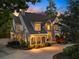 Stunning home featuring stone accents, a welcoming arched porch, and beautifully manicured landscaping at 2480 Flint Creek Dr, Cumming, GA 30041
