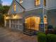 Charming home featuring a three-car garage, stone accents, and a welcoming front entrance with manicured landscaping at 2480 Flint Creek Dr, Cumming, GA 30041