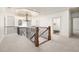 Upstairs hallway with wrought iron railing and neutral carpet at 2480 Flint Creek Dr, Cumming, GA 30041