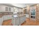 Spacious kitchen with a large center island, granite countertops, custom cabinets, and stainless steel appliances at 2480 Flint Creek Dr, Cumming, GA 30041
