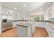 Gourmet kitchen features a large island, granite countertops, stainless steel appliances, and hardwood floors at 2480 Flint Creek Dr, Cumming, GA 30041