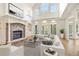 Bright living room with a stone fireplace, built-in shelves, and French doors leading to the exterior at 2480 Flint Creek Dr, Cumming, GA 30041