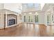 Bright living room featuring a fireplace, hardwood floors, large windows, and access to the balcony at 2480 Flint Creek Dr, Cumming, GA 30041
