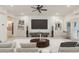 Bright living room featuring recessed lighting, ceiling fan, and built-in shelving at 2480 Flint Creek Dr, Cumming, GA 30041