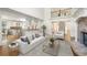 Bright living room with soaring ceilings, stone fireplace, hardwood floors, and open to the kitchen at 2480 Flint Creek Dr, Cumming, GA 30041