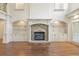 Spacious living room featuring a stone fireplace, hardwood floors, built-in shelves, and natural light at 2480 Flint Creek Dr, Cumming, GA 30041