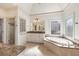 Bright main bathroom features a corner soaking tub and separate tiled shower at 2480 Flint Creek Dr, Cumming, GA 30041