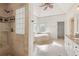 Luxury main bathroom boasts a glass block window and a marble soaking tub at 2480 Flint Creek Dr, Cumming, GA 30041