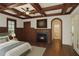 Comfortable main bedroom featuring a fireplace, coffered ceiling, and ensuite bathroom access at 2480 Flint Creek Dr, Cumming, GA 30041