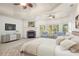 Main bedroom with a trey ceiling, fireplace, and large windows offering lots of natural light at 2480 Flint Creek Dr, Cumming, GA 30041