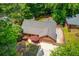 Aerial view of the property showcasing the house, mature trees, and driveway at 2981 Cardinal Lake Dr, Duluth, GA 30096