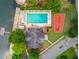 Aerial view featuring a community pool, tennis court, lake access, and well-maintained landscaping at 2981 Cardinal Lake Dr, Duluth, GA 30096