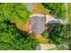 Aerial view of the house featuring the rooftop, driveway, back deck, and mature trees at 2981 Cardinal Lake Dr, Duluth, GA 30096