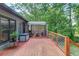 Wooden back deck with a wooden railing, a wooden gazebo and view of lush green trees at 2981 Cardinal Lake Dr, Duluth, GA 30096