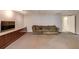 Finished basement featuring carpet, a couch, built-in storage, and a door to another area at 2981 Cardinal Lake Dr, Duluth, GA 30096