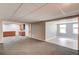 Basement area featuring a cabinet, grey paint, and tiled flooring near a large carpeted open space at 2981 Cardinal Lake Dr, Duluth, GA 30096