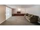 Finished basement featuring carpet, a couch, built-in storage, and access to outdoors through french doors at 2981 Cardinal Lake Dr, Duluth, GA 30096