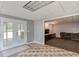 Finished basement with tiled room, walkout door and a den with a large sofa at 2981 Cardinal Lake Dr, Duluth, GA 30096