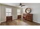 Bedroom with wood flooring, a round mirror, and multiple wood dressers at 2981 Cardinal Lake Dr, Duluth, GA 30096