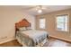 Comfortable bedroom with wood headboard, soft bedding, and natural light from two windows at 2981 Cardinal Lake Dr, Duluth, GA 30096