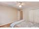 Neutral bedroom featuring wood look floors, ceiling fan and double closets at 2981 Cardinal Lake Dr, Duluth, GA 30096