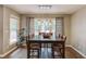 Formal dining room with hanging light fixture, large window, and hardwood floors at 2981 Cardinal Lake Dr, Duluth, GA 30096