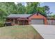 Charming brick home featuring a covered porch, manicured lawn, and attached garage at 2981 Cardinal Lake Dr, Duluth, GA 30096
