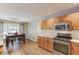 Open kitchen with wood cabinets, stainless steel appliances, and adjacent dining area at 2981 Cardinal Lake Dr, Duluth, GA 30096