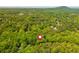 Aerial view of the surrounding area, highlighting green trees, and mountains in the distance at 3925 Rock Mill Pkwy, Marietta, GA 30062