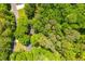 Lush green trees encompass an aerial view of a home with landscaping at 3925 Rock Mill Pkwy, Marietta, GA 30062