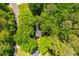 Aerial view of a home nestled among lush green trees and beautiful landscaping at 3925 Rock Mill Pkwy, Marietta, GA 30062