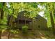 Beautiful backyard with a balcony and patio, surrounded by lush green trees and foliage at 3925 Rock Mill Pkwy, Marietta, GA 30062