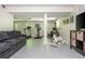 Finished basement with home gym, office space, grey sofa, and white rocking horse at 3925 Rock Mill Pkwy, Marietta, GA 30062