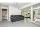 Open basement layout with a grey sofa, exercise equipment, and durable flooring at 3925 Rock Mill Pkwy, Marietta, GA 30062