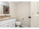 Half bath with granite vanity, new toilet, and linen storage at 3925 Rock Mill Pkwy, Marietta, GA 30062